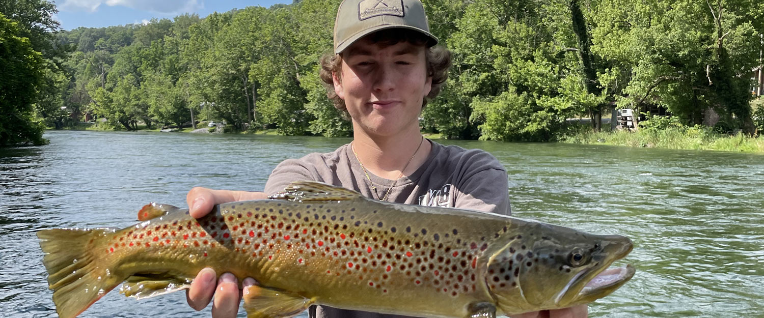 Young man holding big fish